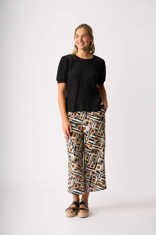 Model wearing Toffee Maze Wide Leg, Cropped Trousers By Foil Available at Beetees Nelson