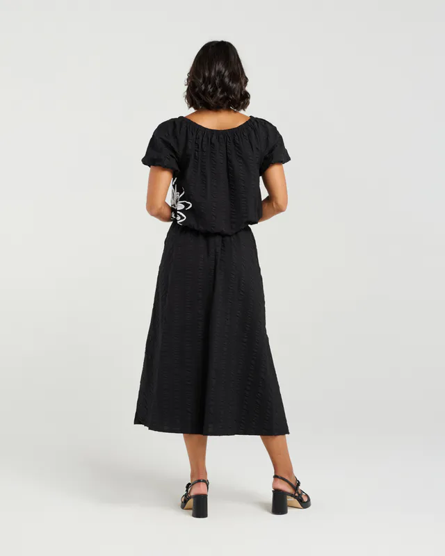 Model wearing Black Bloom Daisy Skirt By Et Alia Available at Beetees Nelson