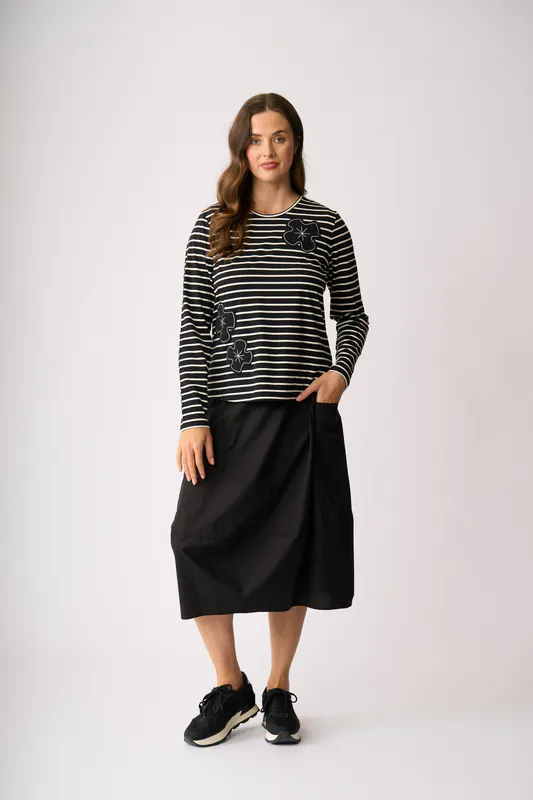 Model wearing Flower Patch Long Sleeve T-Shirt By Foil Available at Beetees Nelson