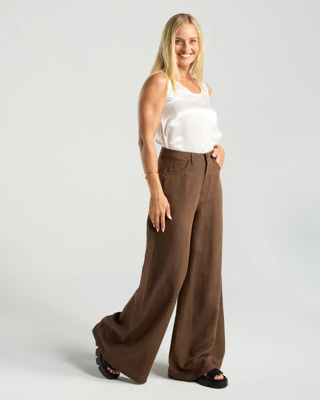 Model wearing Chocolate Leonora Palazzo Linen Pant By Blackstone Available at Beetees Nelson