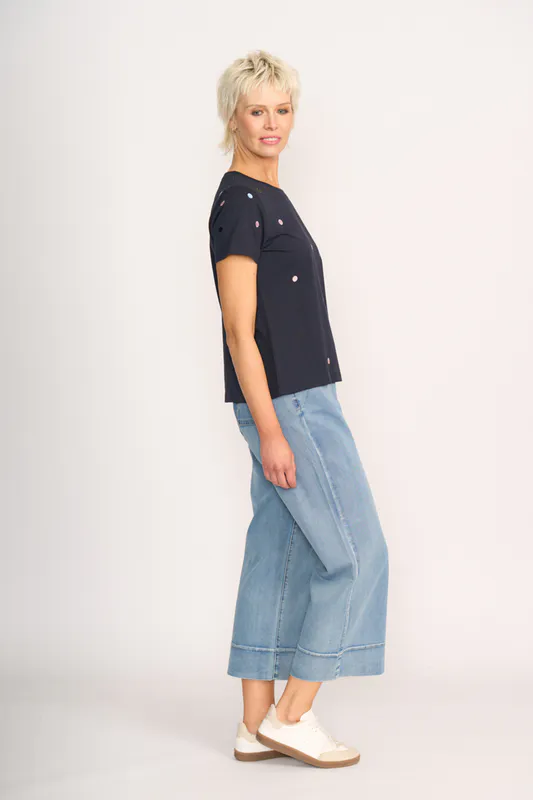 Model wearing Navy Spot T-Shirt- Embroidery By Memo Available at Beetees Nelson
