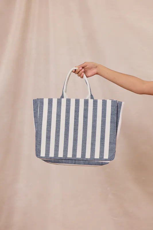 Model wearing Navy Stripe Breeze Tote Bag By Design Nation Available at Beetees Nelson