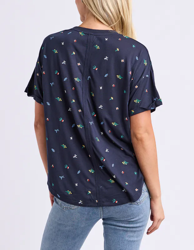 Model wearing Navy Festive Market Tee By Elm Available at Beetees Nelson