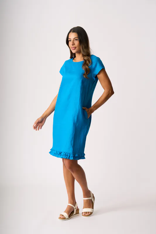 Model wearing Ocean Ruffle Dreams Dress By Foil Available at Beetees Nelson