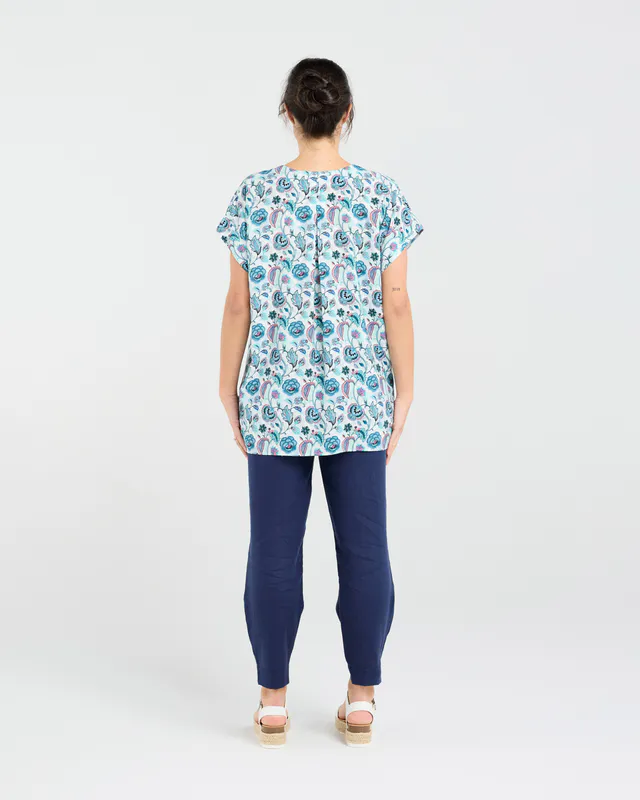 Model wearing Teal Retro Flower Octivia Scoop Hem Top By Blackstone Available at Beetees Nelson