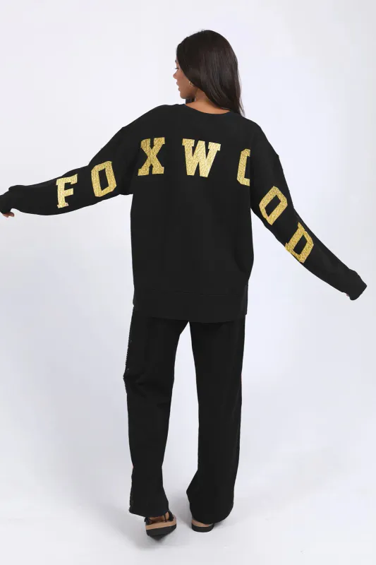 Model wearing Black/Gold Metallic Intervel Crew By Foxwood Available at Beetees Nelson