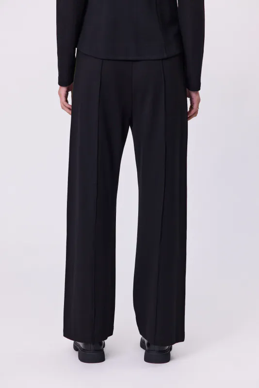 Model wearing Black Olive Batten Pant By Navy & No. Available at Beetees Nelson