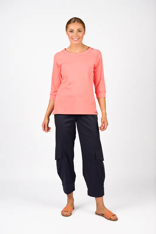 Model wearing Coral Status Tee By Knewe Available at Beetees Nelson
