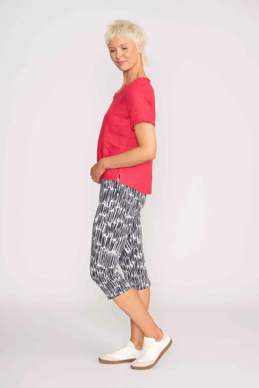 Model wearing Coral V Benefits Top By Foil Available at Beetees Nelson