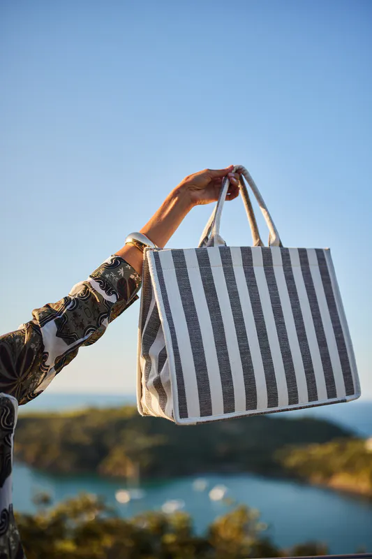 Model wearing Navy Stripe Breeze Tote Bag By Design Nation Available at Beetees Nelson