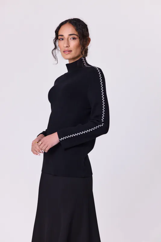 Model wearing Black Astral Turtle Knit By Navy & Co. Available at Beetees Nelson