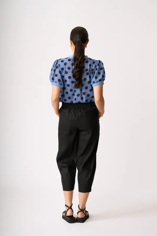 Model wearing Black Barrel Along Trousers By Oh Three Available at Beetees Nelson