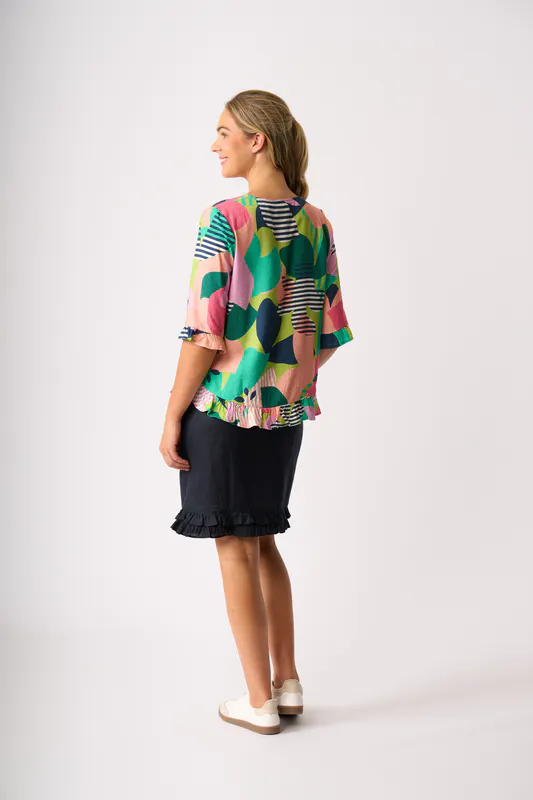 Model wearing True Navy Ruffle Dreams Skirt By Foil Available at Beetees Nelson