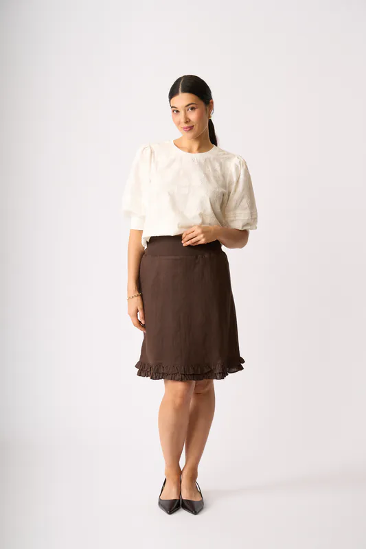 Model wearing Cocoa Ruffle Dreams Skirt By Foil Available at Beetees Nelson