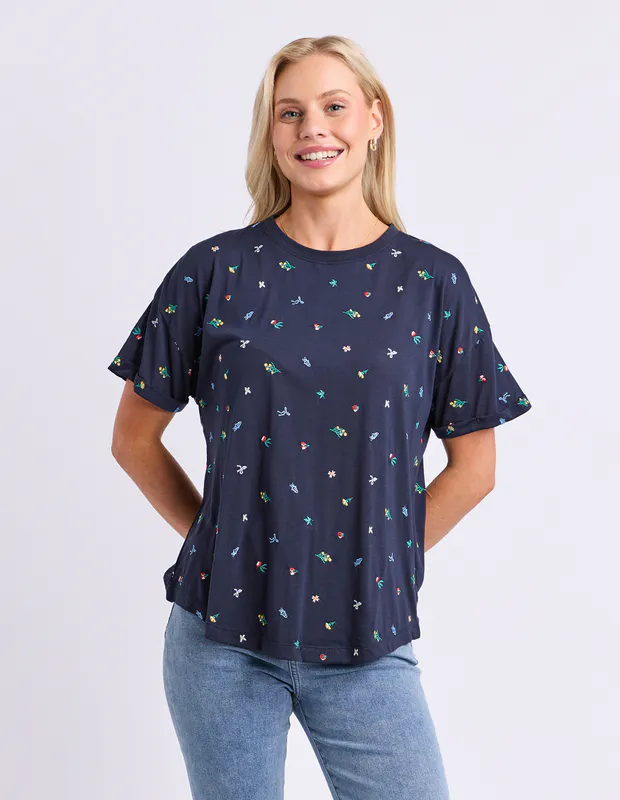 Model wearing Navy Festive Market Tee By Elm Available at Beetees Nelson