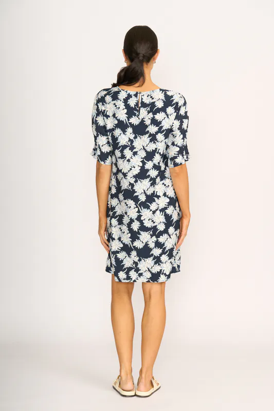 Model wearing Navy Sketch Floral Dress - Shirr The Cuff By Foil Available at Beetees Nelson
