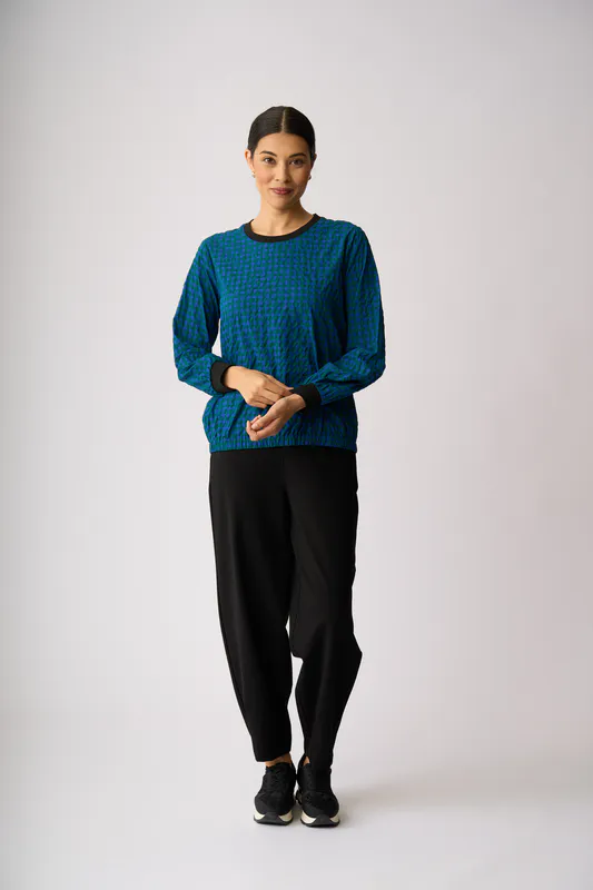 Model wearing Blue Spot Elastic Hem Detail Top By Memo Available at Beetees Nelson