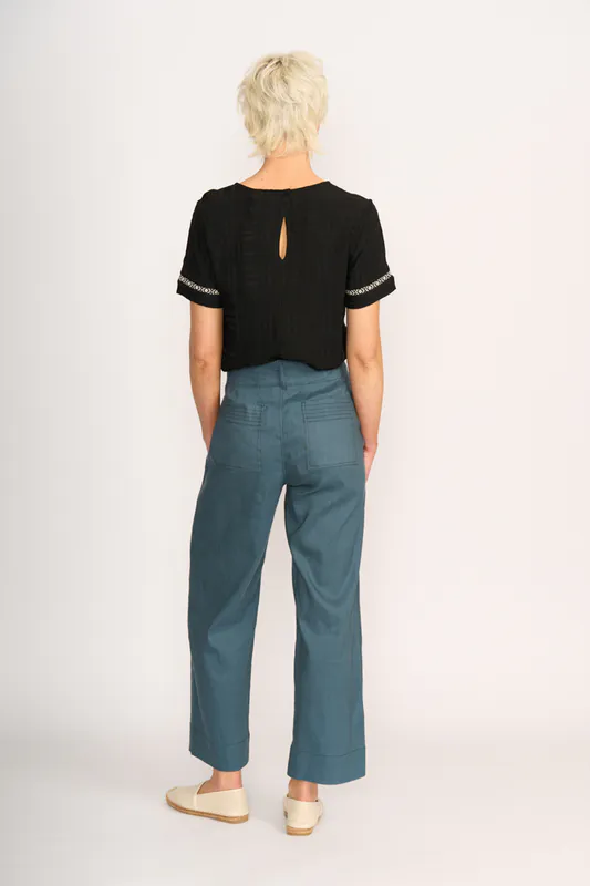 Model wearing Steel Wide Leg Contrast Stitch Trousers By Oh Three Available at Beetees Nelson