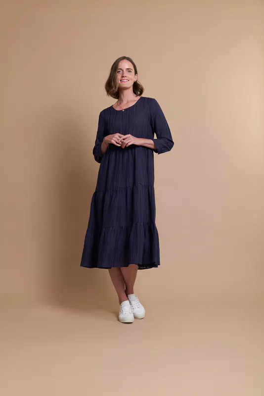 Model wearing Navy Coloured Dress - Tiered, Cuff Sleeve By Oh Three Available at Beetees Nelson