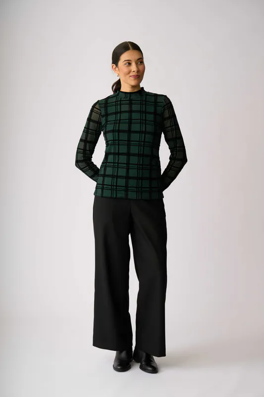 Model wearing Green Check Top - Long Sleeve Polo Neck By Foil Available at Beetees Nelson