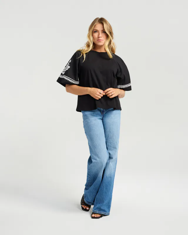 Model wearing Black Stella Top By NMBR Rose Available at Beetees Nelson