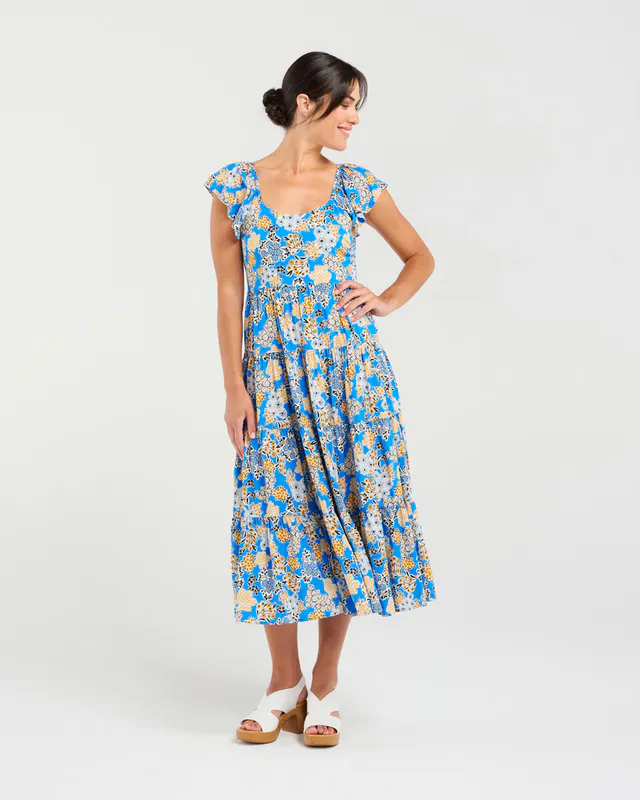 Model wearing Blue Bouquet Brielle Flutter Sleeve Dress By Blackstone Available at Beetees Nelson