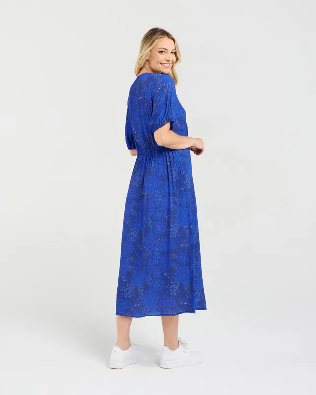 Model wearing Blue Pansy Maribelle Gathered Bust Dress By Blackstone Available at Beetees Nelson