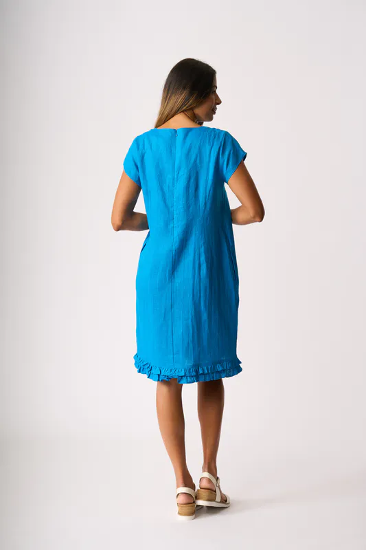 Model wearing Ocean Ruffle Dreams Dress By Foil Available at Beetees Nelson