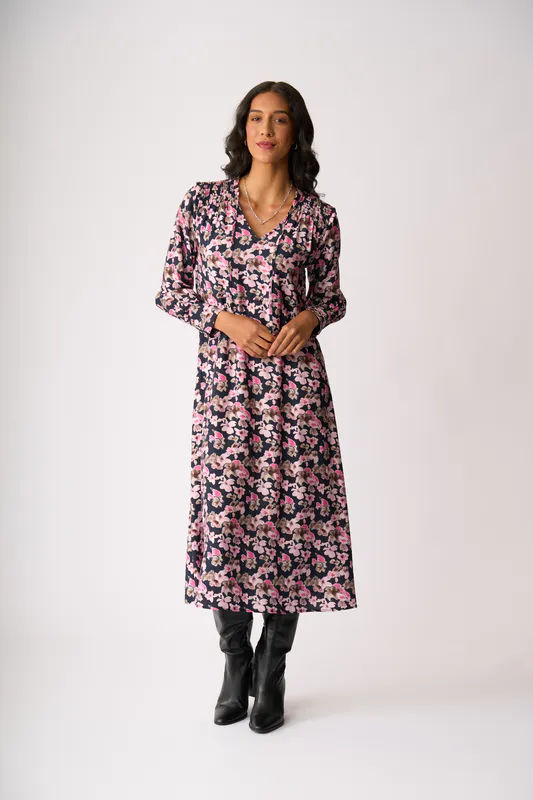 Model wearing Floral Smudge Shirred Shoulder Dress By Foil Available at Beetees Nelson