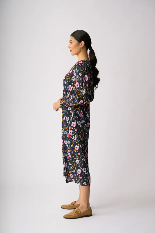 Model wearing Garden Delight Curved & Shirred Dress By Foil Available at Beetees Nelson