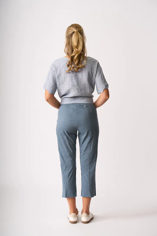 Model wearing Pale Blue Cross Dye Scalloped Top By Foil Available at Beetees Nelson