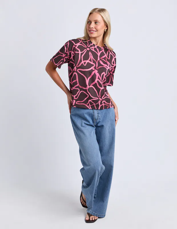 Model wearing Chocolate Palma Tee Available at Beetees Nelson