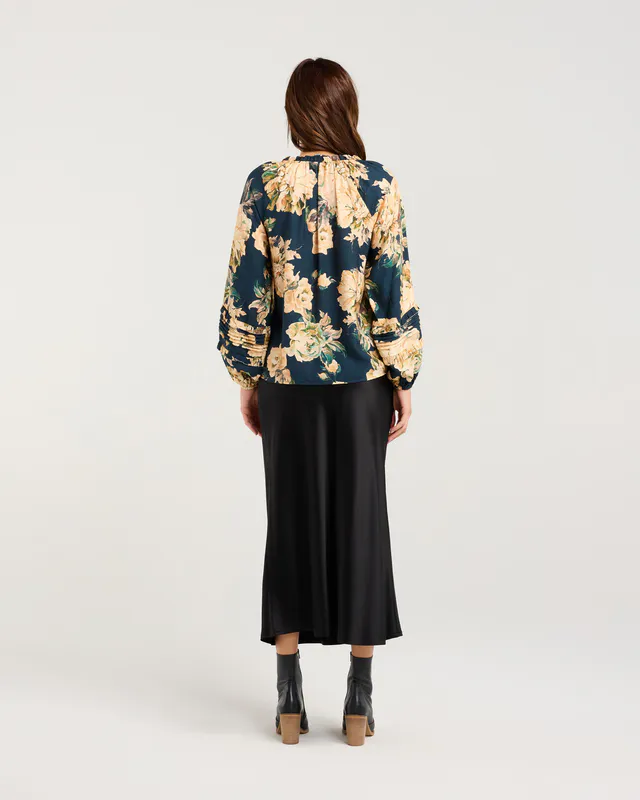 Model wearing Majolica Blue Winter Rose Christie Frill Neck Top By Blackstone Available at Beetees Nelson