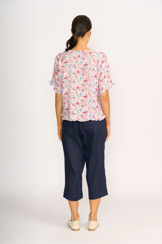 Model wearing Romantic Blooms Top - Ruffles & Scoop Hem By Preen Available at Beetees Nelson