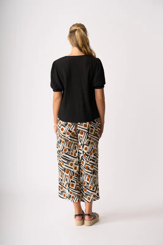Model wearing Toffee Maze Wide Leg, Cropped Trousers By Foil Available at Beetees Nelson