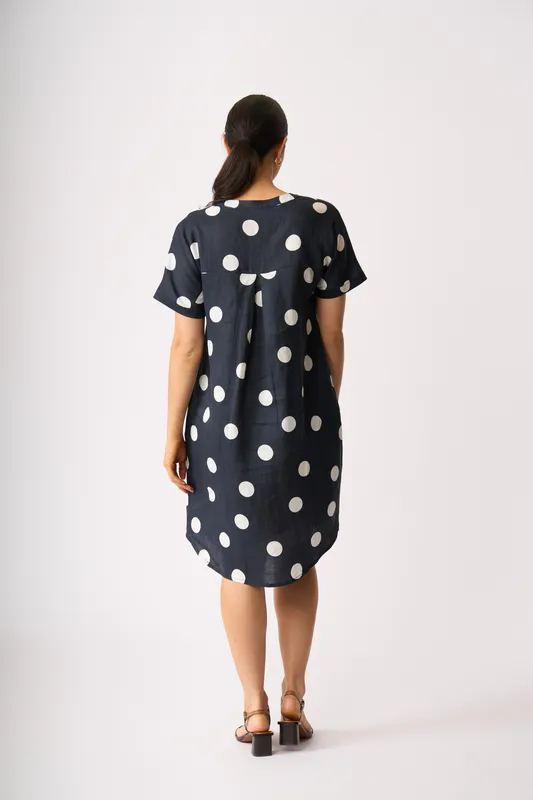 Model wearing True Navy Spot Back Pleat Dress By Foil Available at Beetees Nelson