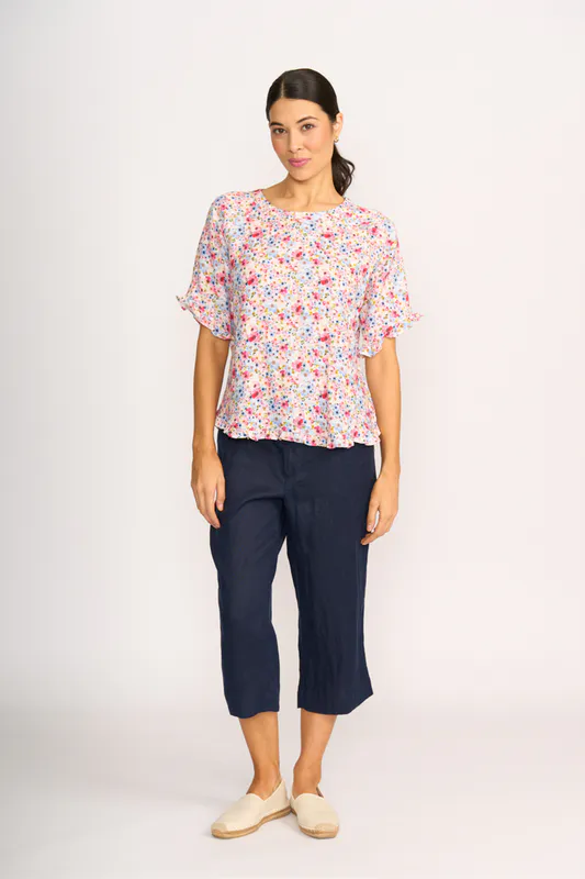 Model wearing Romantic Blooms Top - Ruffles & Scoop Hem By Preen Available at Beetees Nelson