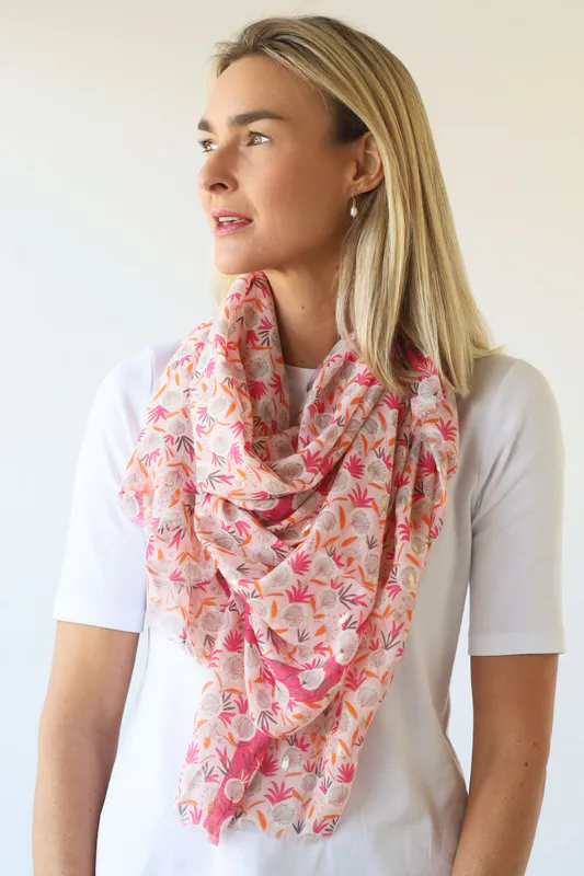 Model wearing Pinks/Orange Dandelion Print Scarf with Gold Foil By Archer House Available at Beetees Nelson
