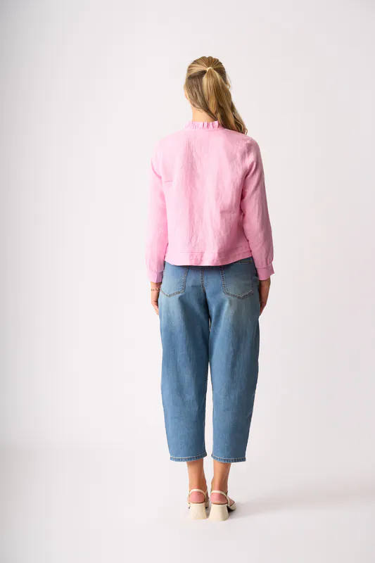 Model wearing Pink Ruffle Neck Jacket By Foil Available at Beetees Nelson