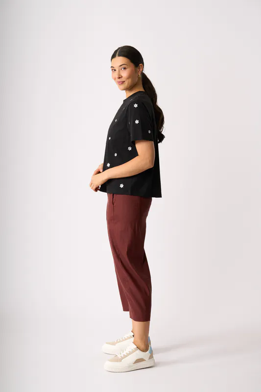 Model wearing Black Floral Embroidered Fun Tshirt By Memo Available at Beetees Nelson