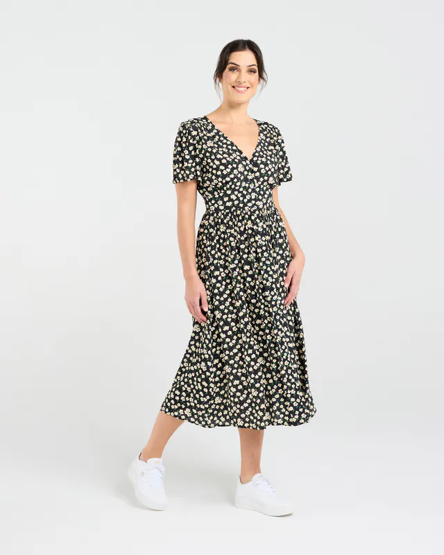 Model wearing Daisy Chain Print Gigi V-neck Button Front Dress By Blackstone Avaialble at Beetees Nelson