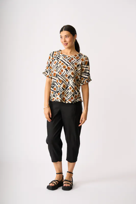 Model wearing Toffee Maze Ruffles & Scoop Hem Top By Foil Available at Beetees Nelson
