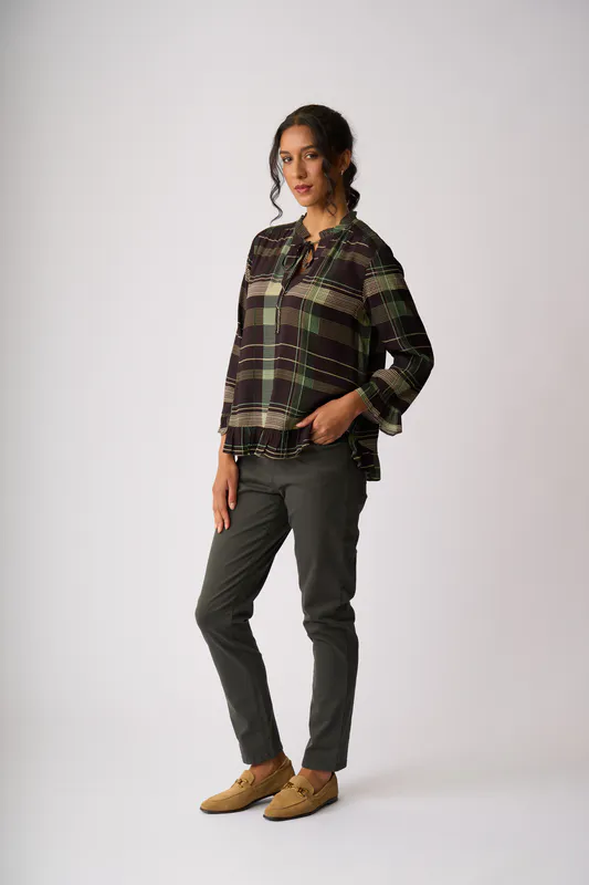 Model wearing Sage Check Ruffle Neck, Scoop Hem Top By Foil Available at Beetees Nelson