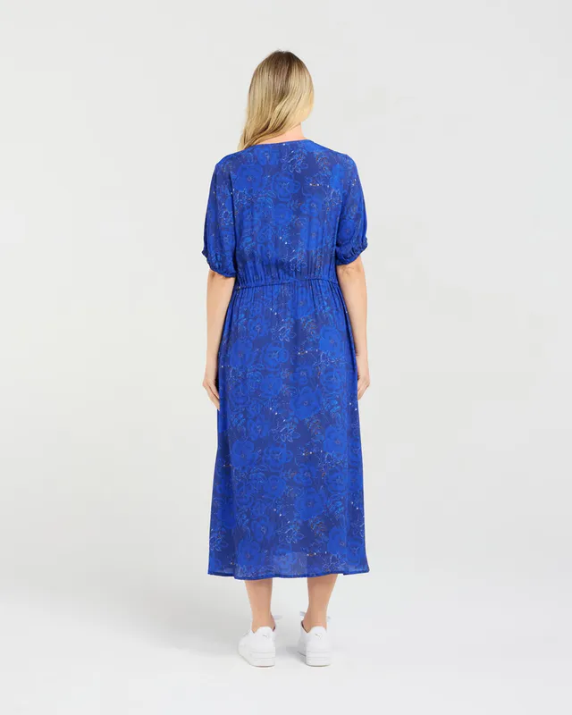 Model wearing Blue Pansy Maribelle Gathered Bust Dress By Blackstone Available at Beetees Nelson