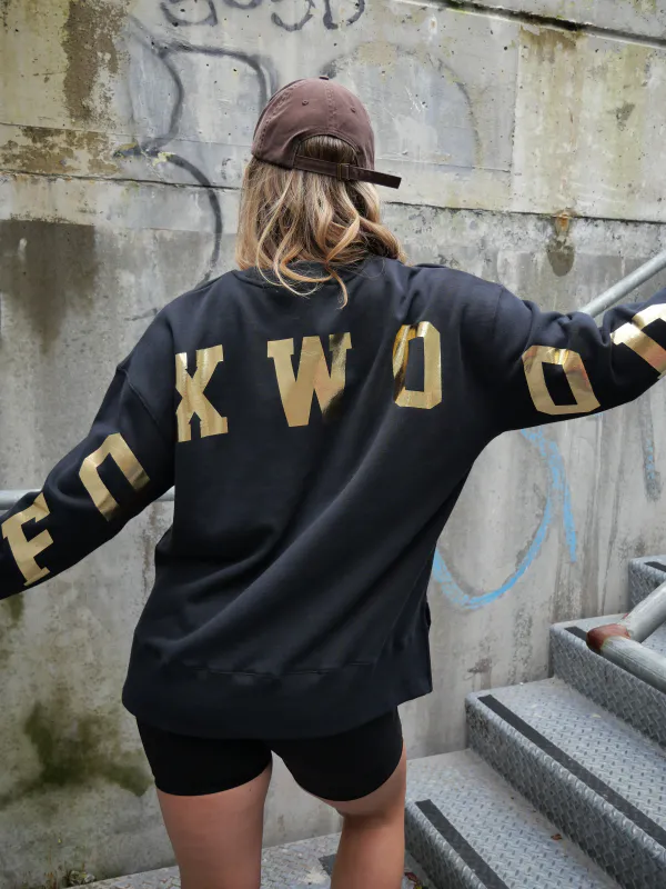 Model wearing Black/Gold Metallic Intervel Crew By Foxwood Available at Beetees Nelson