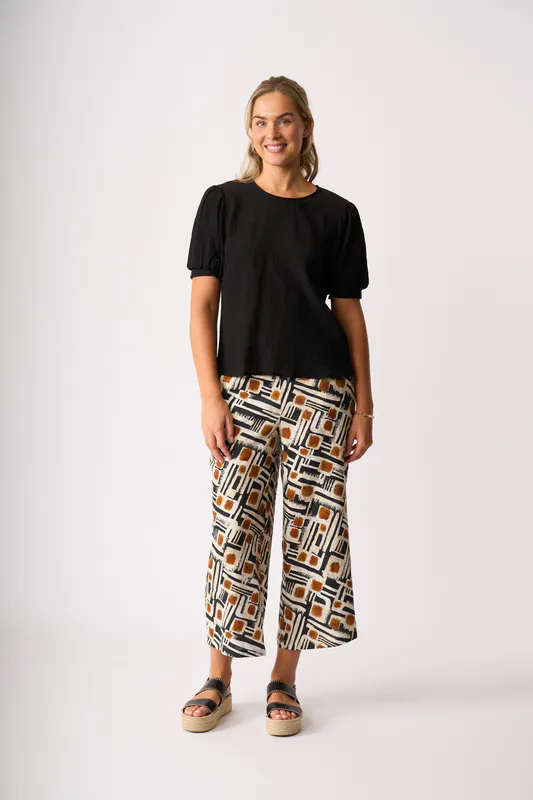 Model wearing Toffee Maze Wide Leg, Cropped Trousers By Foil Available at Beetees Nelson
