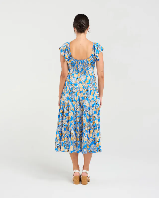 Model wearing Blue Bouquet Brielle Flutter Sleeve Dress By Blackstone Available at Beetees Nelson