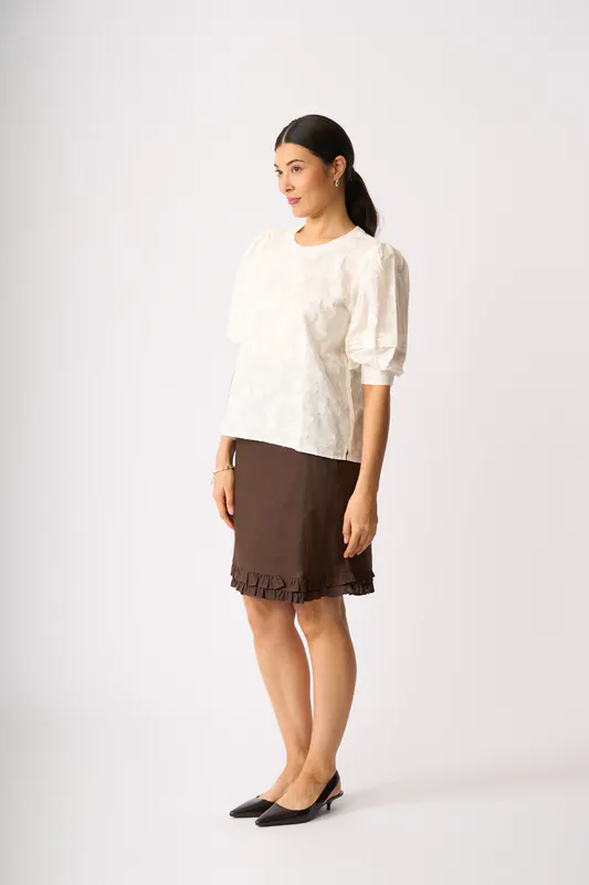 Model wearing Cocoa Ruffle Dreams Skirt By Foil Available at Beetees Nelson
