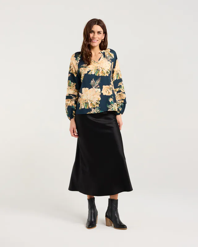 Model wearing Majolica Blue Winter Rose Christie Frill Neck Top By Blackstone Available at Beetees Nelson