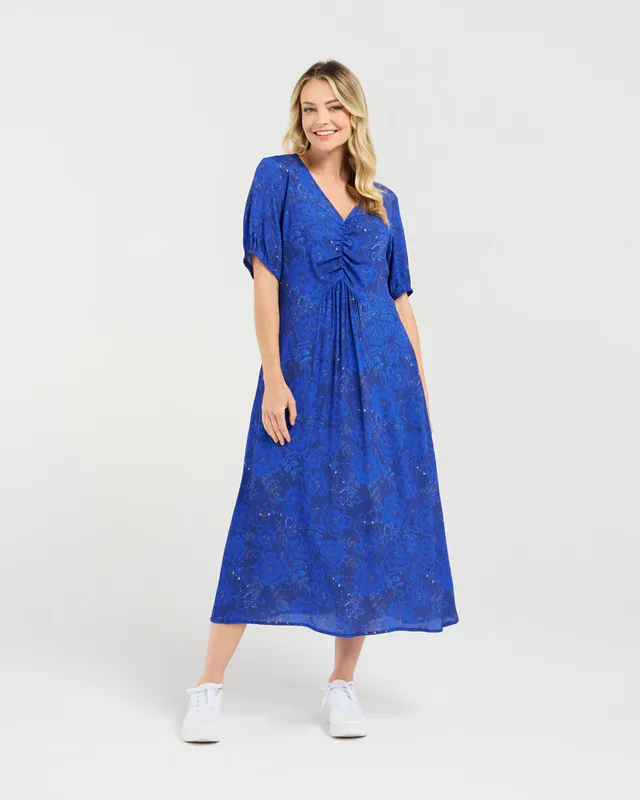 Model wearing Blue Pansy Maribelle Gathered Bust Dress By Blackstone Available at Beetees Nelson